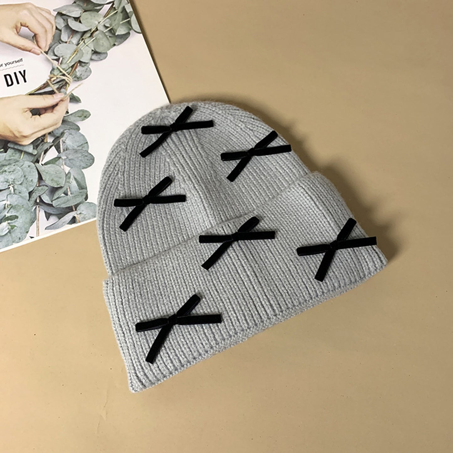 Knitted Beanie with Black Bow Accents - Cute & Stylish Winter Hat for Cold Weather