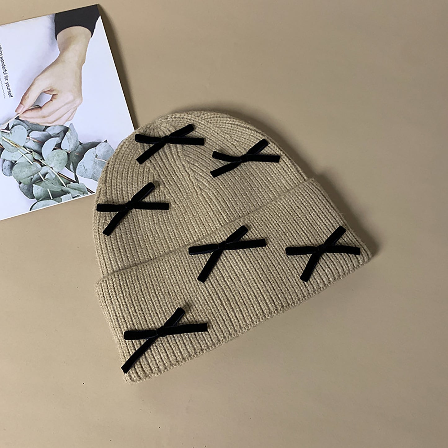 Knitted Beanie with Black Bow Accents - Cute & Stylish Winter Hat for Cold Weather