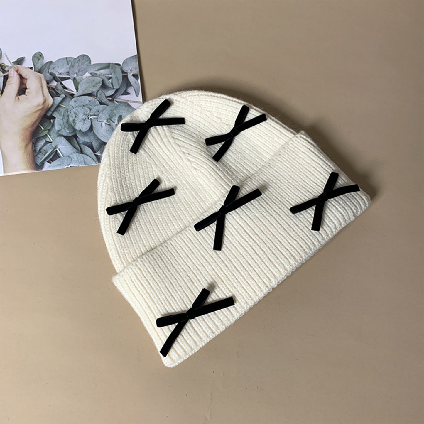 Knitted Beanie with Black Bow Accents - Cute & Stylish Winter Hat for Cold Weather