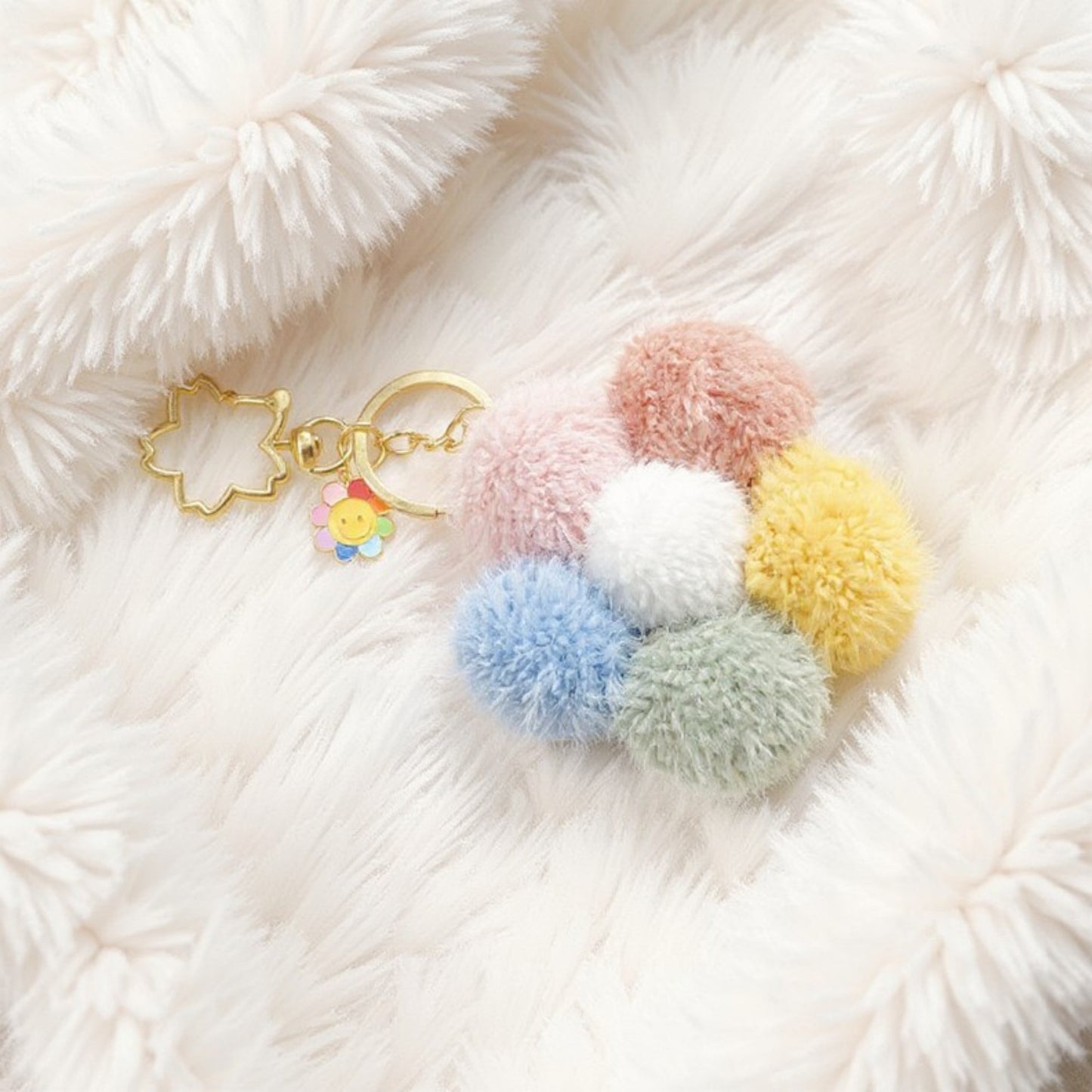 Multicolor Pom Pom Keychain with Gold Flower Charm and Smiley Accent