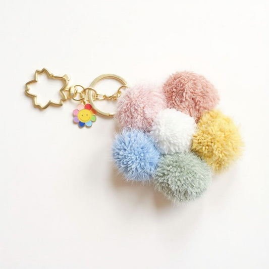 Multicolor Pom Pom Keychain with Gold Flower Charm and Smiley Accent
