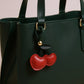 Faux Leather Cherry Heart Keychain with Black Leaf Strap and Gold Rivet Detail