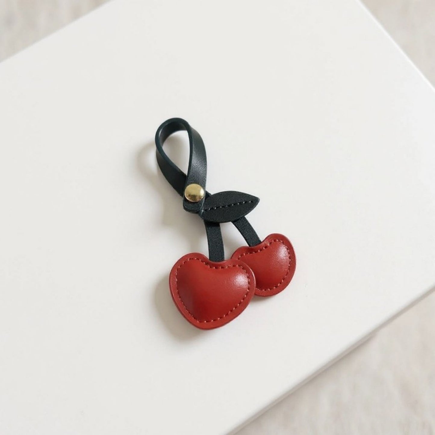 Faux Leather Cherry Heart Keychain with Black Leaf Strap and Gold Rivet Detail