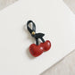 Faux Leather Cherry Heart Keychain with Black Leaf Strap and Gold Rivet Detail