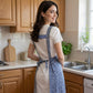 Floral Pattern Kitchen Apron with Adjustable Shoulder Straps Front Pocket and Decorative Trim Detail