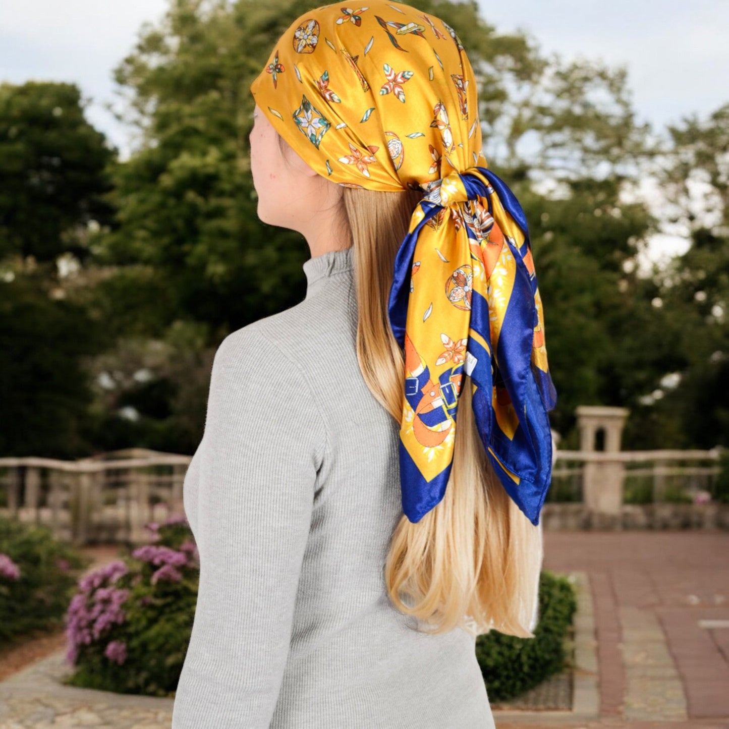 Vintage-Inspired Satin Square Scarves with Vibrant Patterns and Bold Feather and Butterfly Motifs
