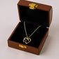 Interlocking Heart Pendant Necklace with Crystal Accents and Polished Metal Design on a Delicate Chain