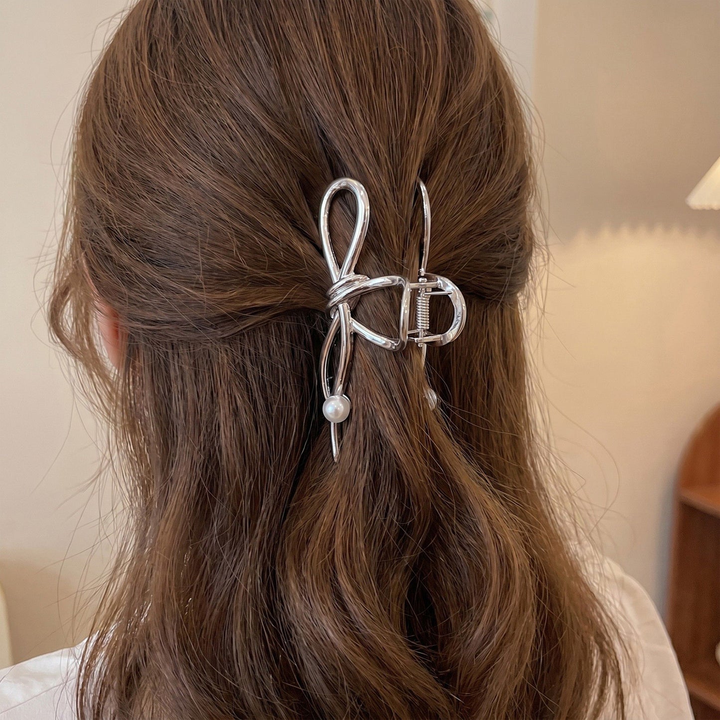 Bow Shaped Hair Clip with Faux Pearl Accent and Open Frame Design 4.5x1in