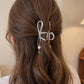 Bow Shaped Hair Clip with Faux Pearl Accent and Open Frame Design 4.5x1in