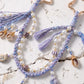 Purple Coastal Bag Charm with Star Clips Pearl Look Beads Braided Cord and Tassels