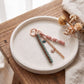 Multi-Strand Braided Cord and Shell Bag Charm Keychain