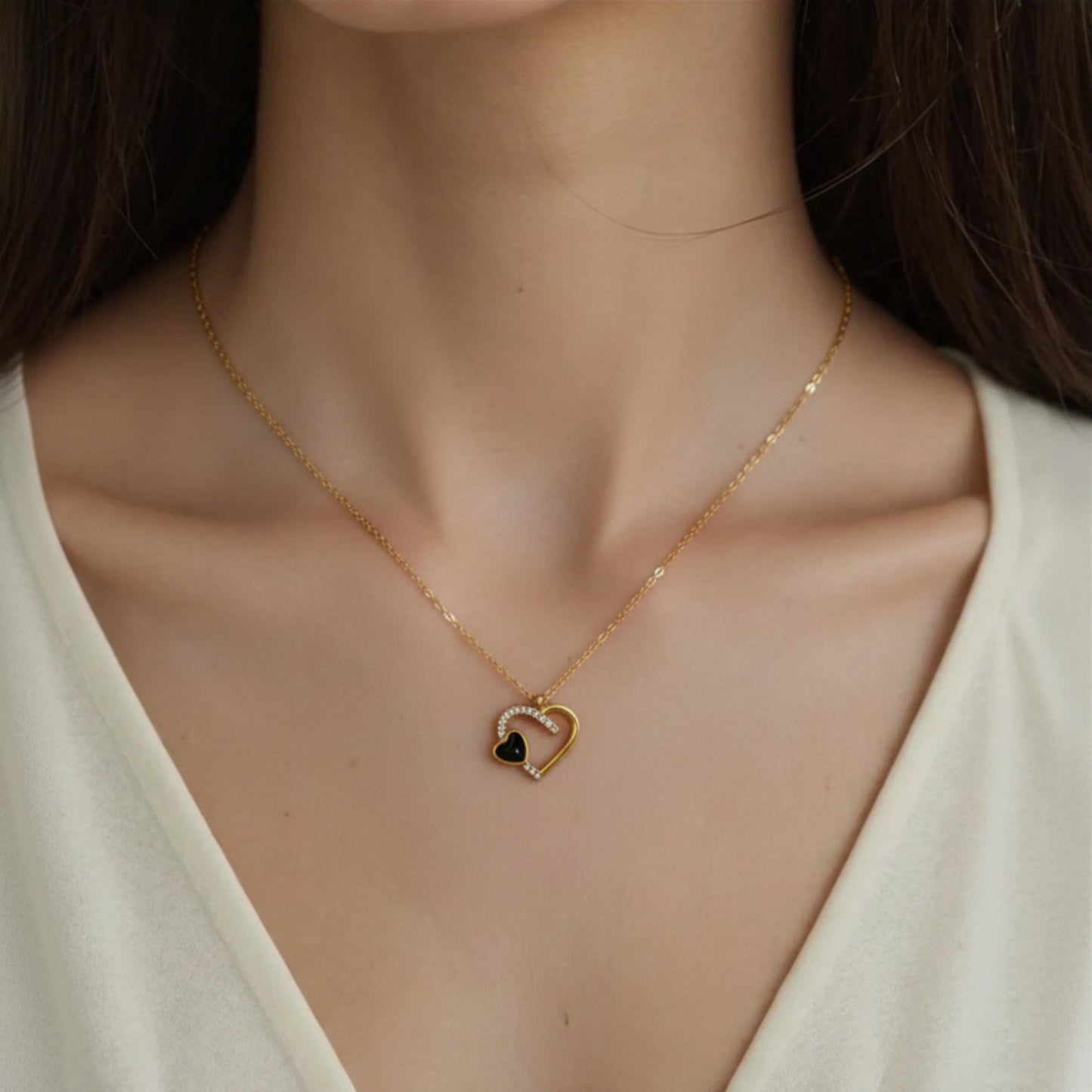 Interlocking Heart Pendant Necklace with Crystal Accents and Polished Metal Design on a Delicate Chain