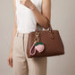 Peach Bag Charm with Braided Leather Loop and Gold Tone Hardware