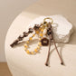 Brown Braided Rope Bag Charm with Beaded Loop and Flower Accent