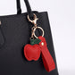 Apple Bag Charm with Faux Leather Strap and Gold Tone Hardware