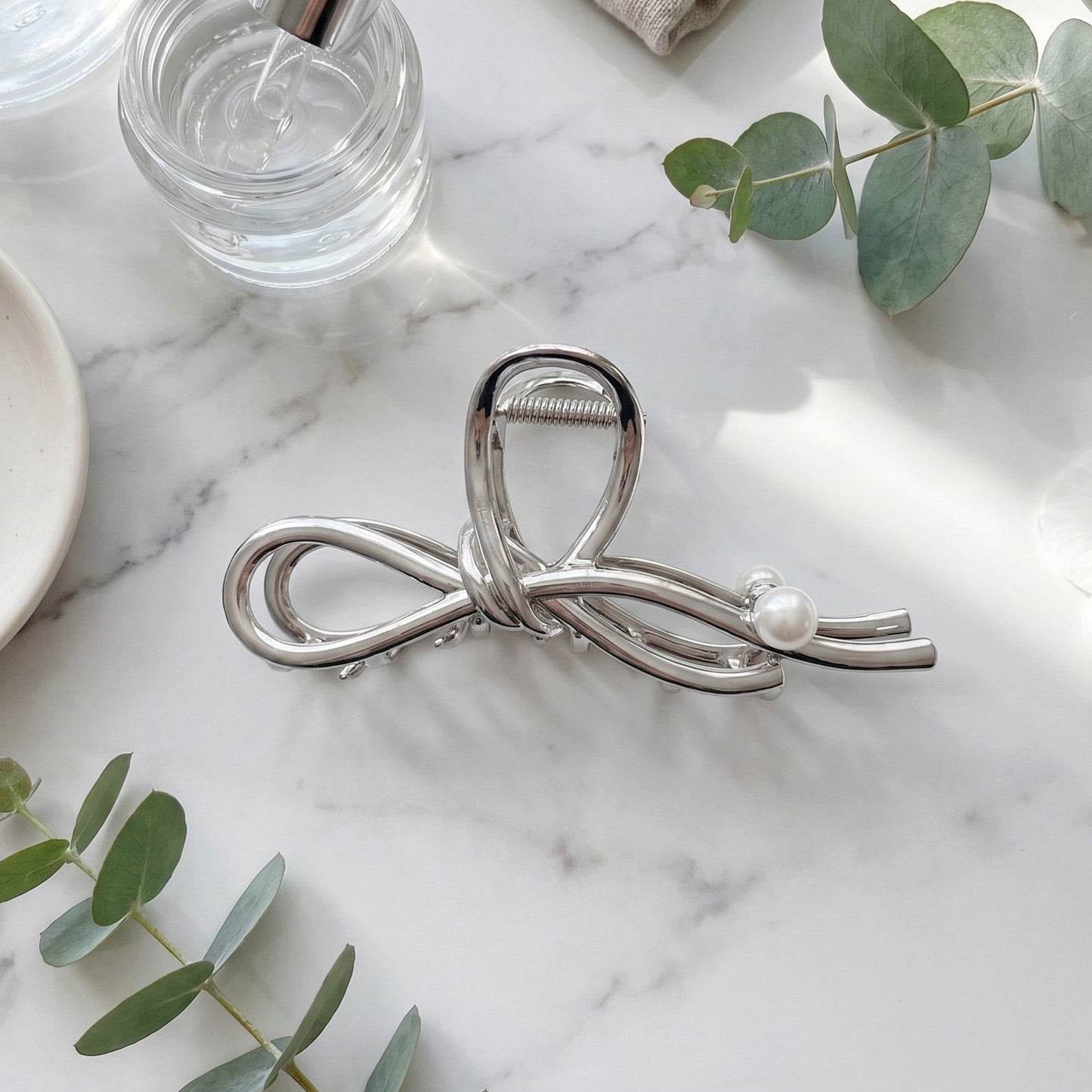Bow Shaped Hair Clip with Faux Pearl Accent and Open Frame Design 4.5x1in