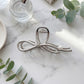 Bow Shaped Hair Clip with Faux Pearl Accent and Open Frame Design 4.5x1in