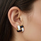 Women's Interlocking Enamel Square Stud Earrings with Gold Tone Frame and Classic Two-Tone Design