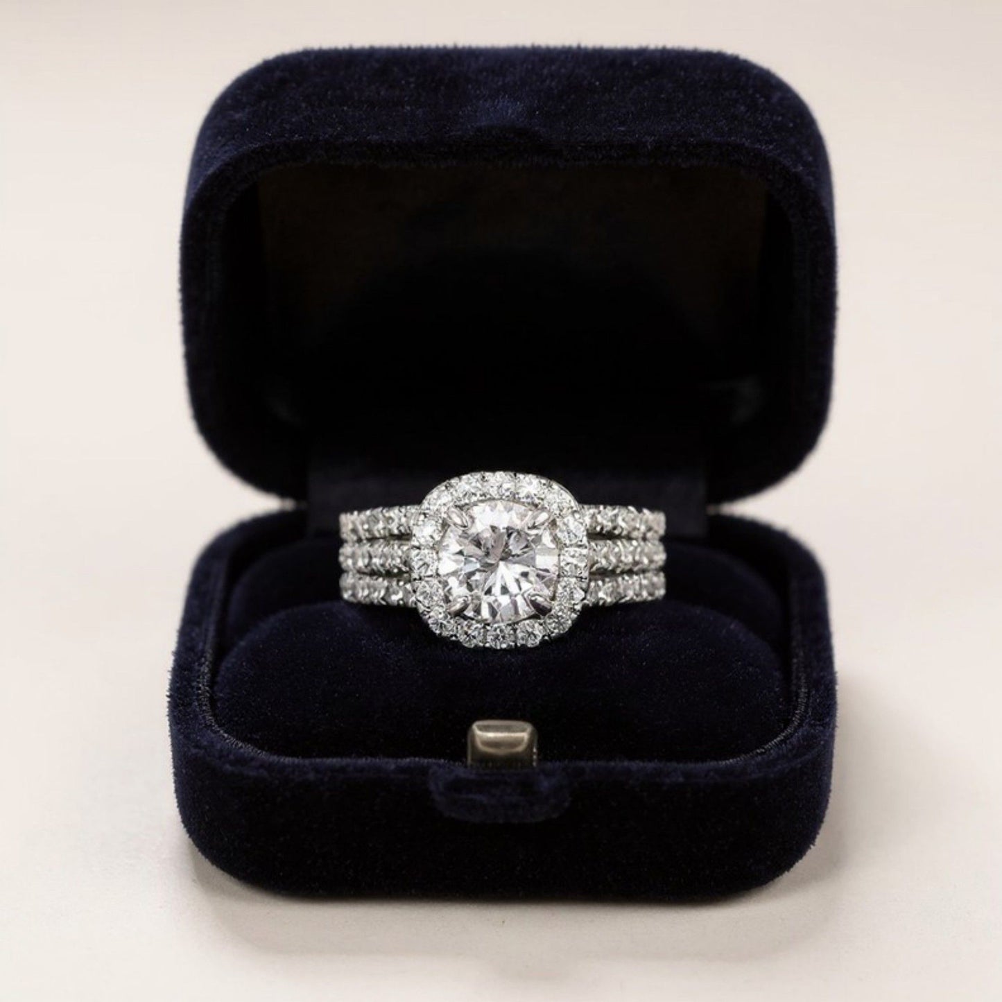 Women's Cushion Halo Engagement Ring with Round Cut Center Stone and Triple Band Design