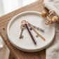 Multi-Strand Braided Cord and Shell Bag Charm Keychain