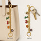 Gold Tone Charm Chain Bag Accessory with Cherry Dinosaur Heart Flower and Horseshoe Accents