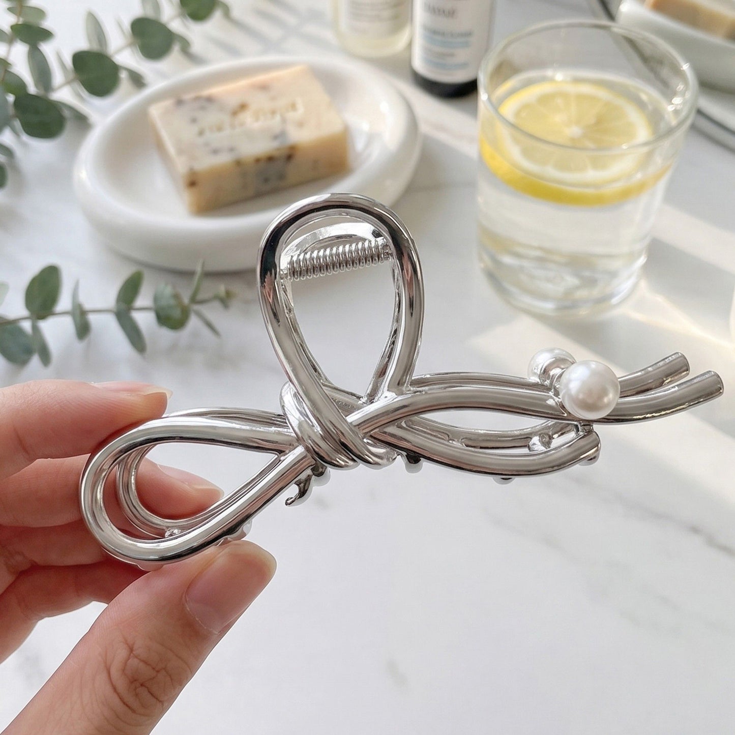 Bow Shaped Hair Clip with Faux Pearl Accent and Open Frame Design 4.5x1in