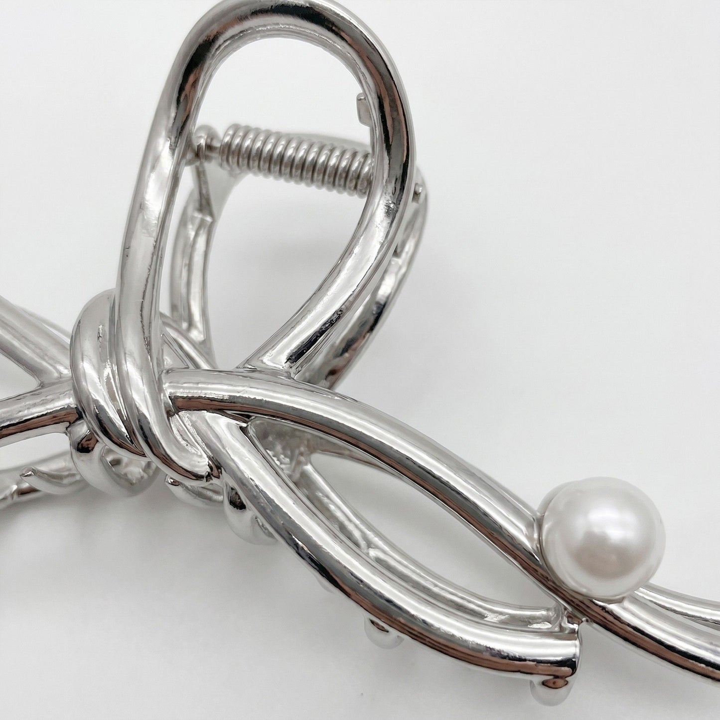 Bow Shaped Hair Clip with Faux Pearl Accent and Open Frame Design 4.5x1in