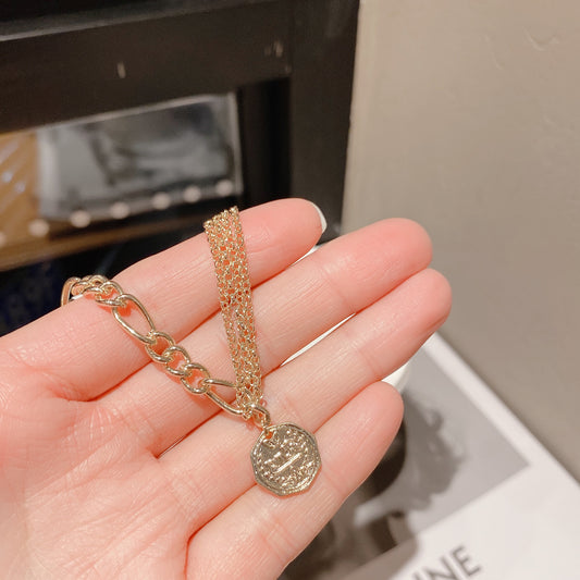 Asymmetrical Gold Chain Bracelet with Coin