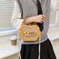 Woven Basket Crossbody Bag with Decorative Gold Links